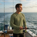 Deepwater Crew Co. olive green long-sleeve performance tee with UPF 44+ sun protection, worn by a man fishing on a boat.