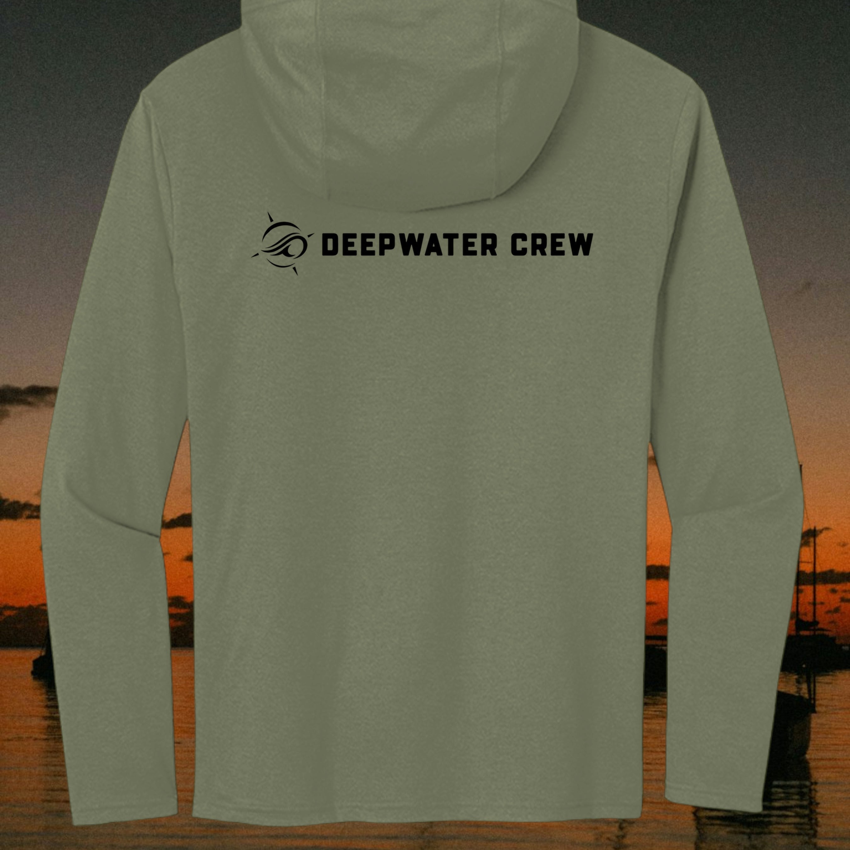 Deepwater Crew Co. olive green long sleeve tri-blend hoodie with black logo on the back against a sunset coastal backdrop