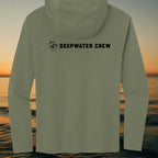 Deepwater Crew Co. olive green long sleeve tri-blend hoodie with black logo on the back against a sunset ocean view.