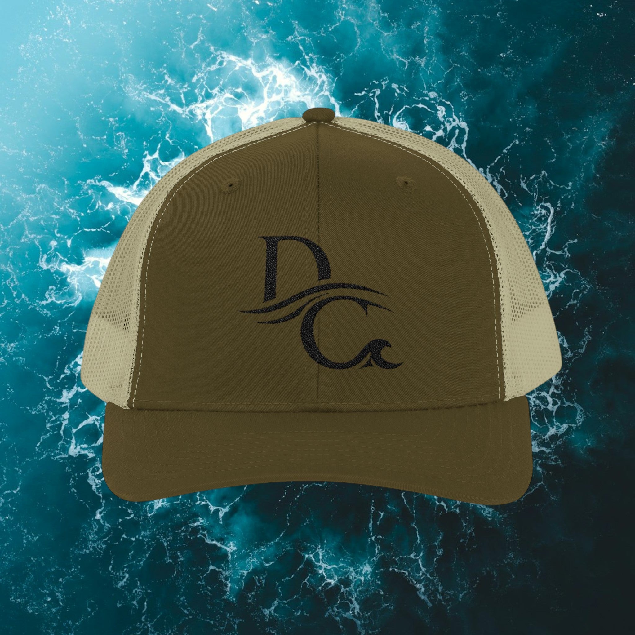 Deepwater Crew Co. olive green and tan trucker hat with embroidered DC wave logo. Structured, mid-profile, mesh back.