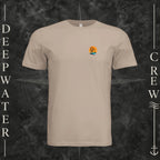 Dust Deepwater Crew Co. Salt Runs Deep crewneck T-shirt, front view with small tropical DC sunset-and-wave crest logo.