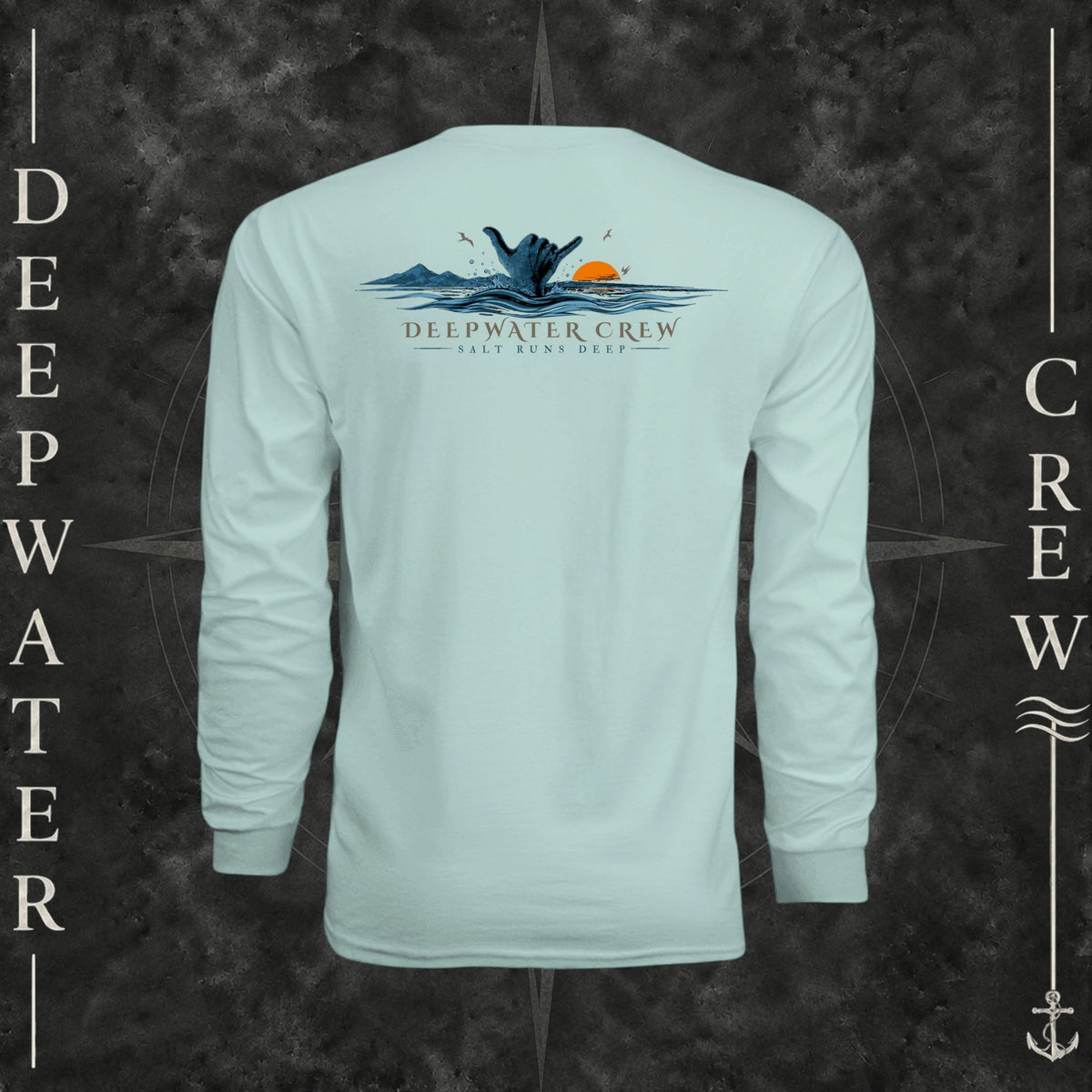 Pastel Mint Deepwater Crew Co. Salt Runs Deep UPF 44+ long-sleeve performance shirt, back view with shaka hand, ocean waves, distant mountains, orange sunset, seabirds, and “Salt Runs Deep” lettering.