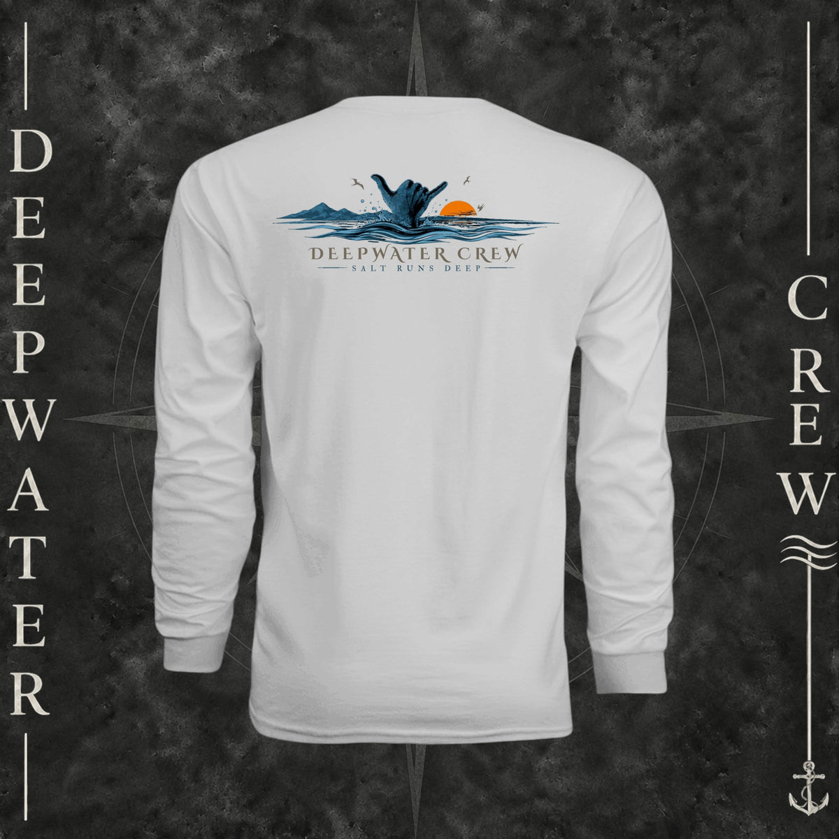 Silver Deepwater Crew Co. Salt Runs Deep UPF 44+ long-sleeve performance shirt, back view with shaka hand, ocean waves, distant mountains, orange sunset, seabirds, and “Salt Runs Deep” lettering.