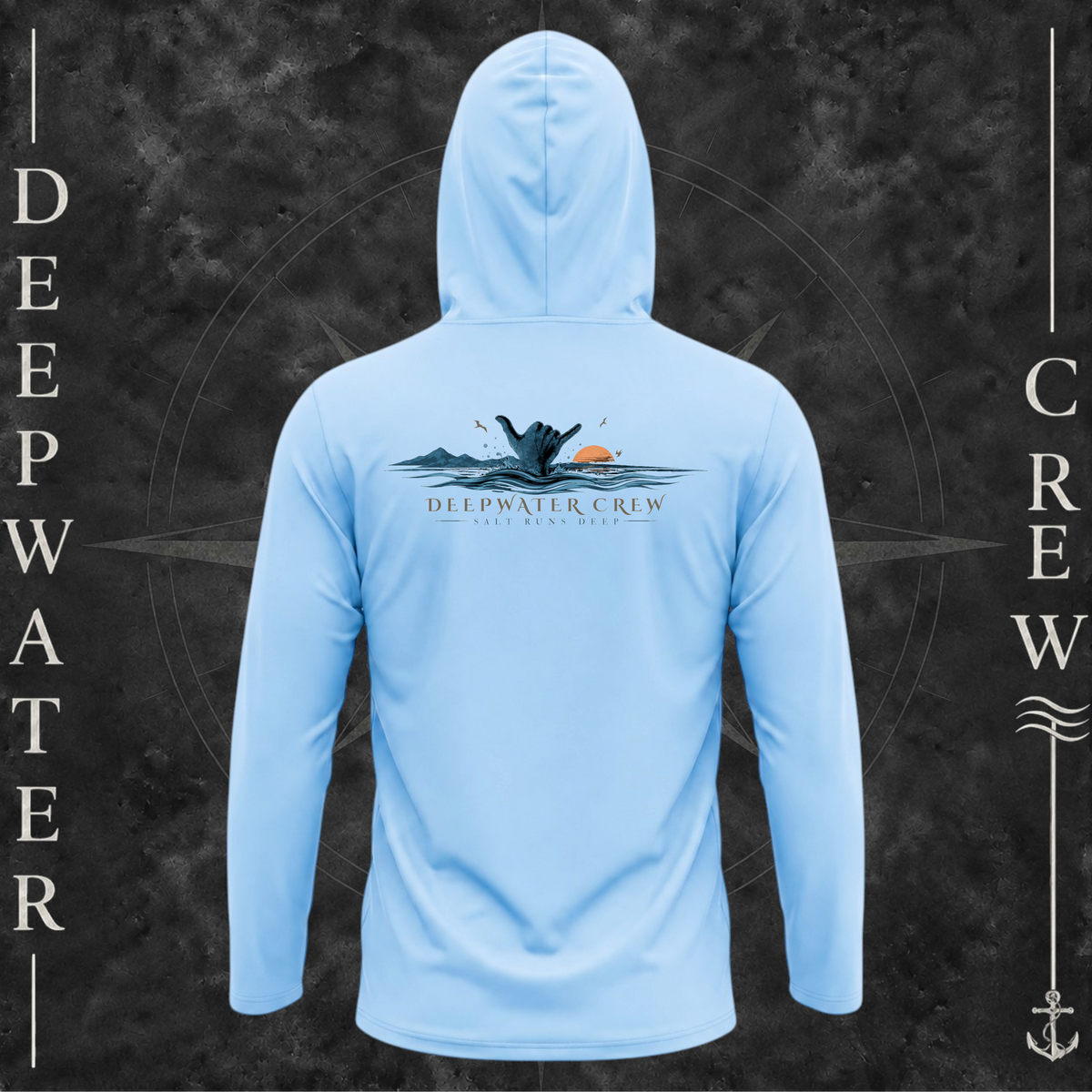 Blue Mist Deepwater Crew Co. Salt Runs Deep UPF 50+ performance hoodie, back view with shaka hand, ocean waves, distant mountains, orange sunset, seabirds, and “Salt Runs Deep” lettering.