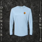 Blue Mist Deepwater Crew Co. Salt Runs Deep UPF 50+ performance hoodie, front view with small tropical DC sunset-and-wave crest logo.