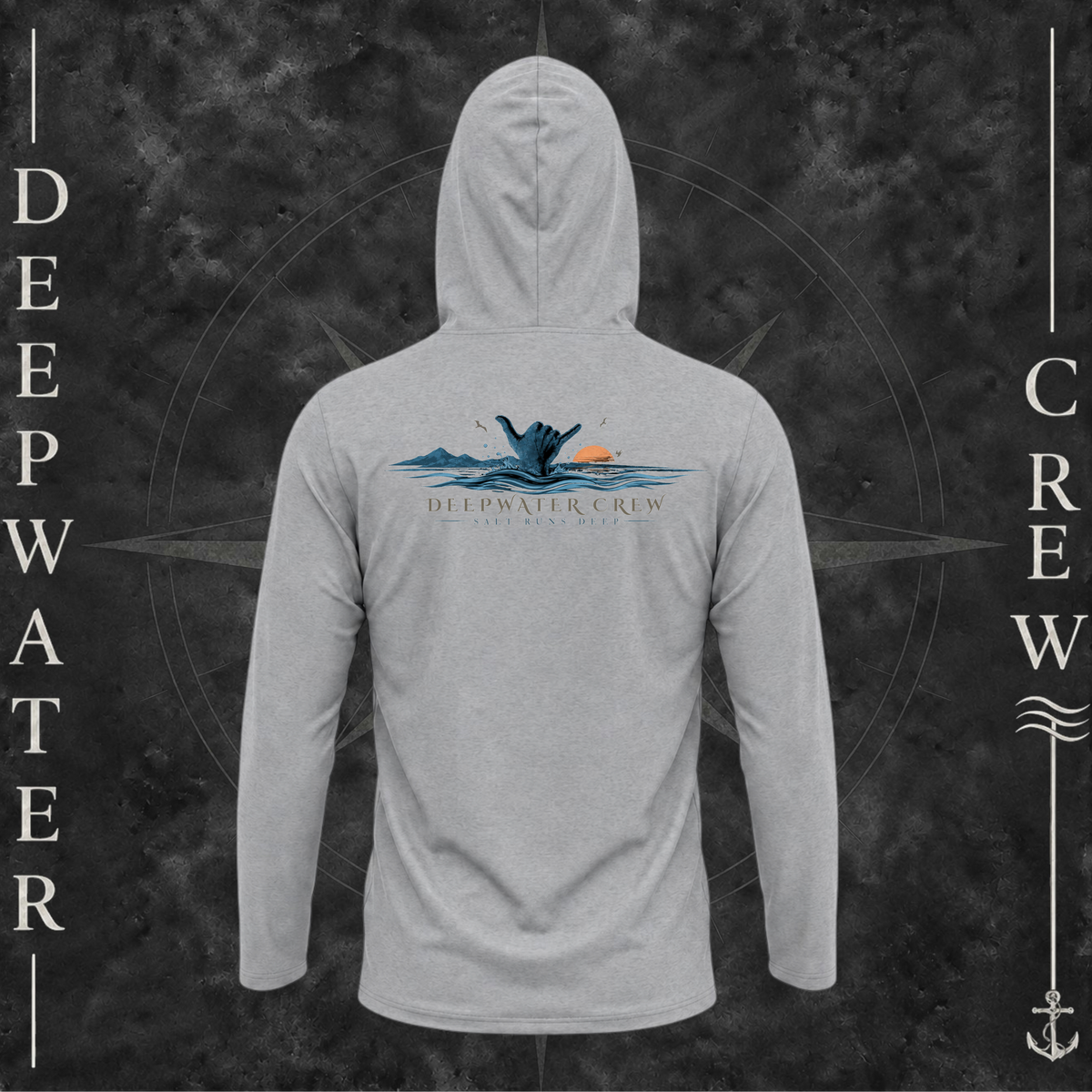 Medium Grey Deepwater Crew Co. Salt Runs Deep UPF 50+ performance hoodie, back view with shaka hand, ocean waves, distant mountains, orange sunset, seabirds, and “Salt Runs Deep” lettering.