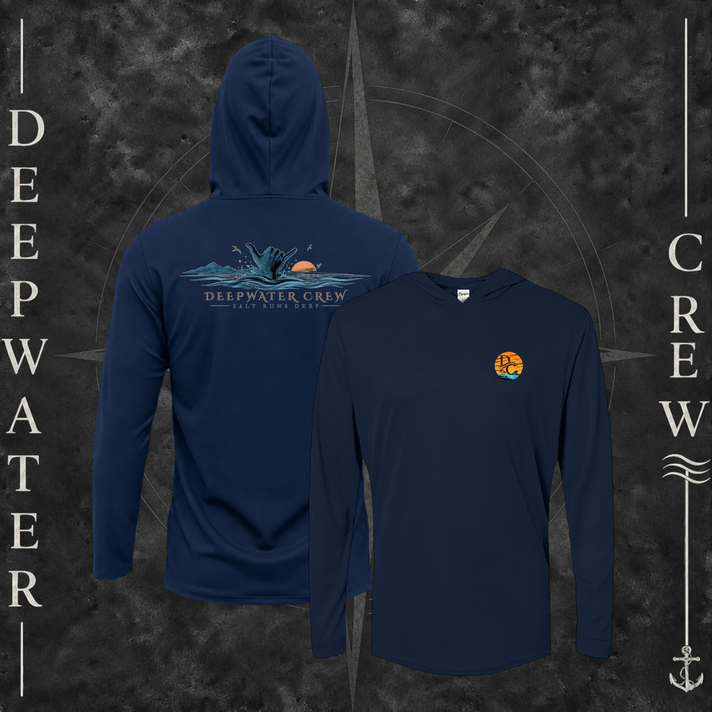Navy Deepwater Crew Co. Salt Runs Deep UPF 50+ performance hoodie showing front and back views with tropical DC sunset-and-wave chest logo and shaka, ocean waves, mountains, sunset, seabirds, and Salt Runs Deep back graphic.