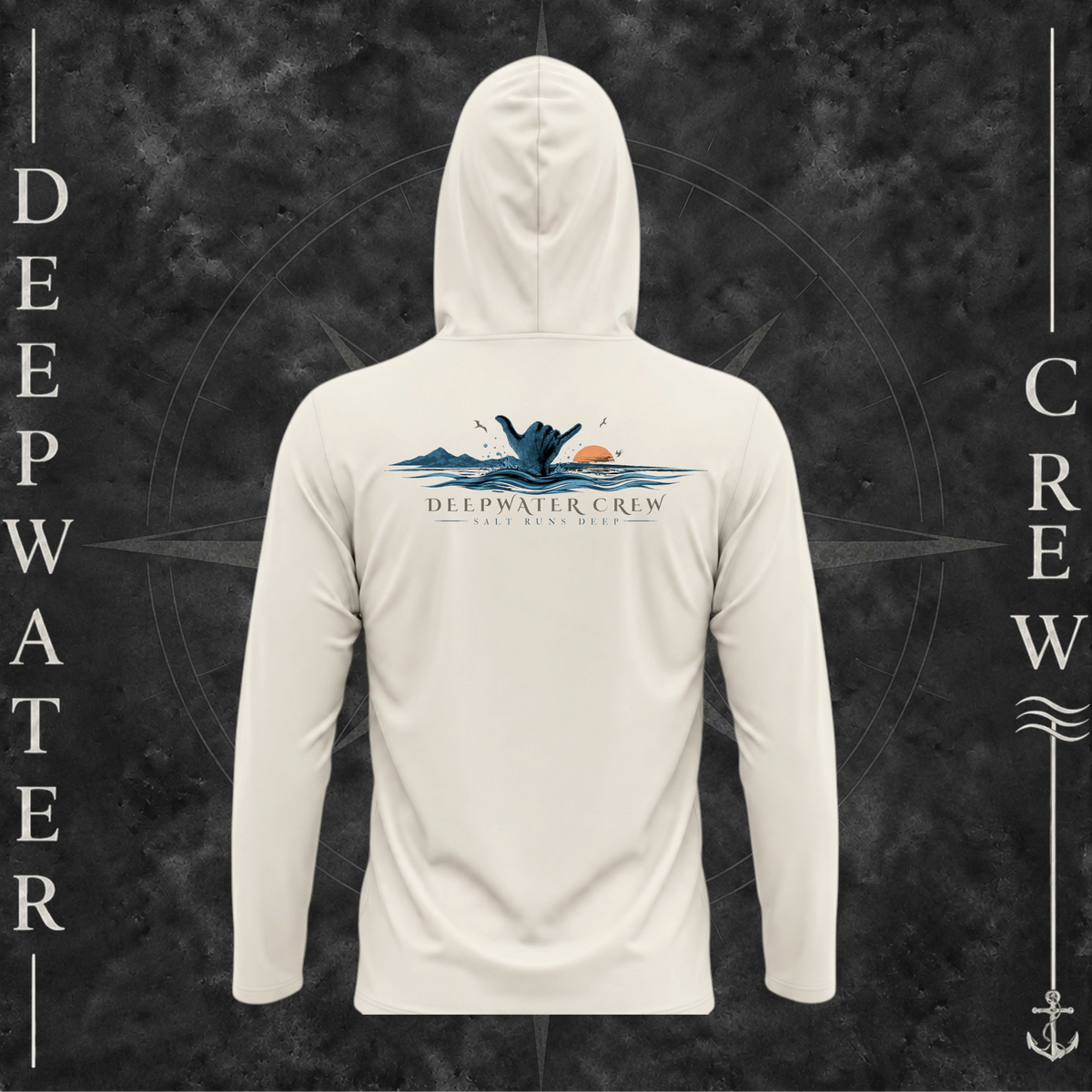 Sand Deepwater Crew Co. Salt Runs Deep UPF 50+ performance hoodie, back view with shaka hand, ocean waves, distant mountains, orange sunset, seabirds, and “Salt Runs Deep” lettering.
