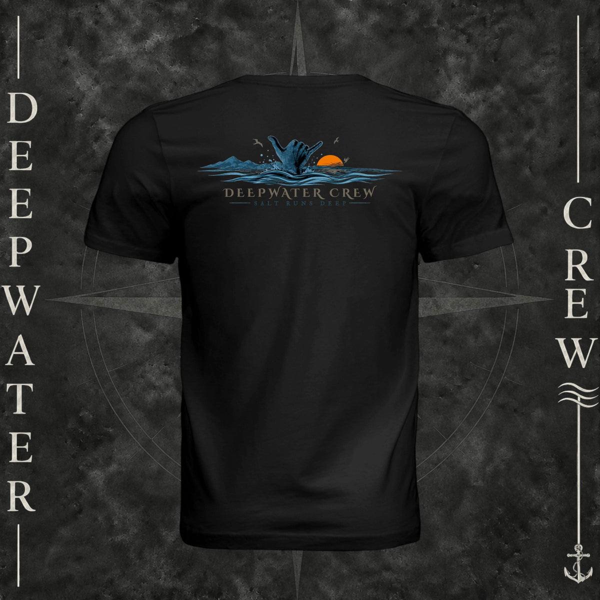 Vintage Black Deepwater Crew Co. Salt Runs Deep crewneck T-shirt, back view with shaka hand, ocean waves, distant mountains, orange sunset, seabirds, and “Salt Runs Deep” lettering.