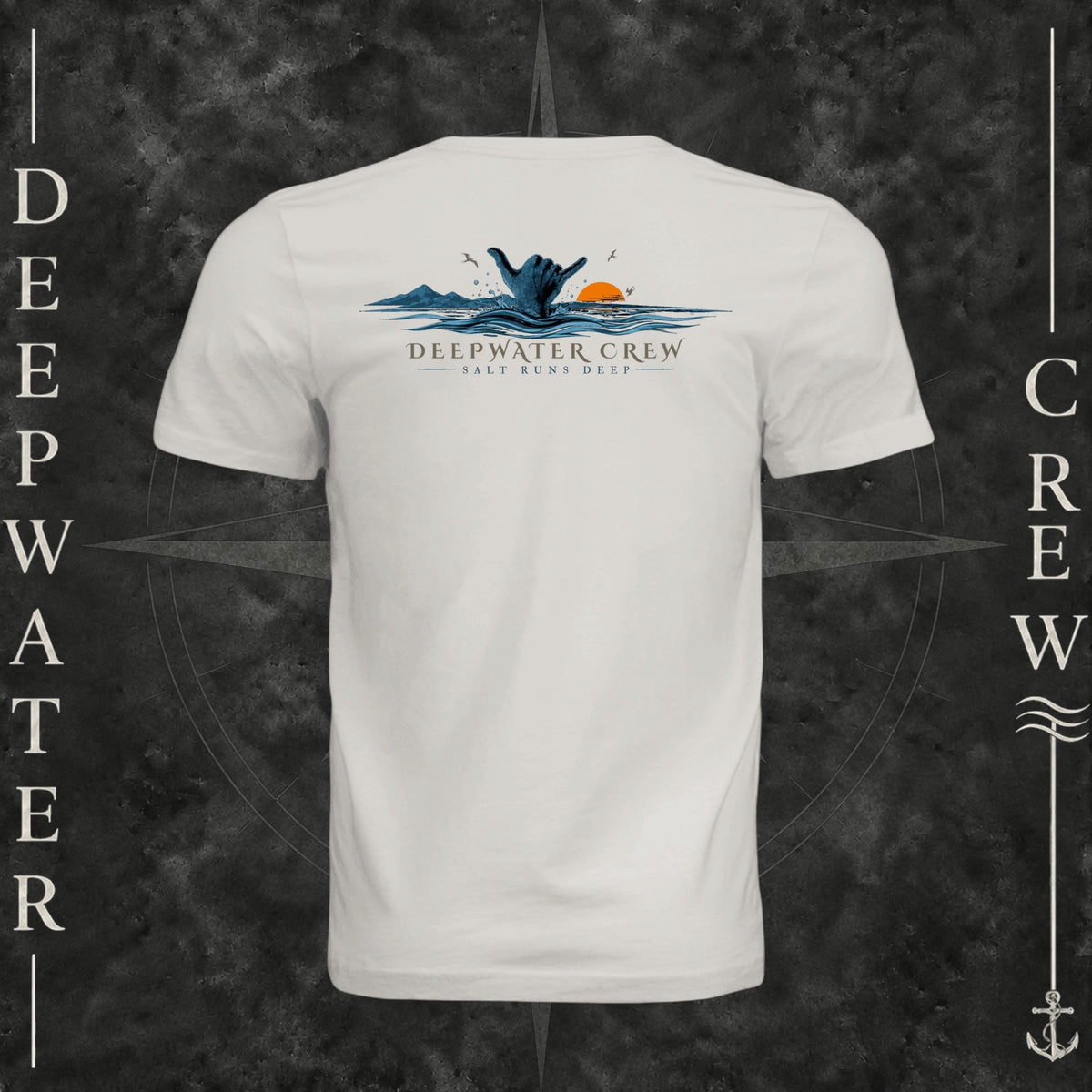 Vintage White Deepwater Crew Co. Salt Runs Deep crewneck T-shirt, back view with shaka hand, ocean waves, distant mountains, orange sunset, seabirds, and “Salt Runs Deep” lettering.