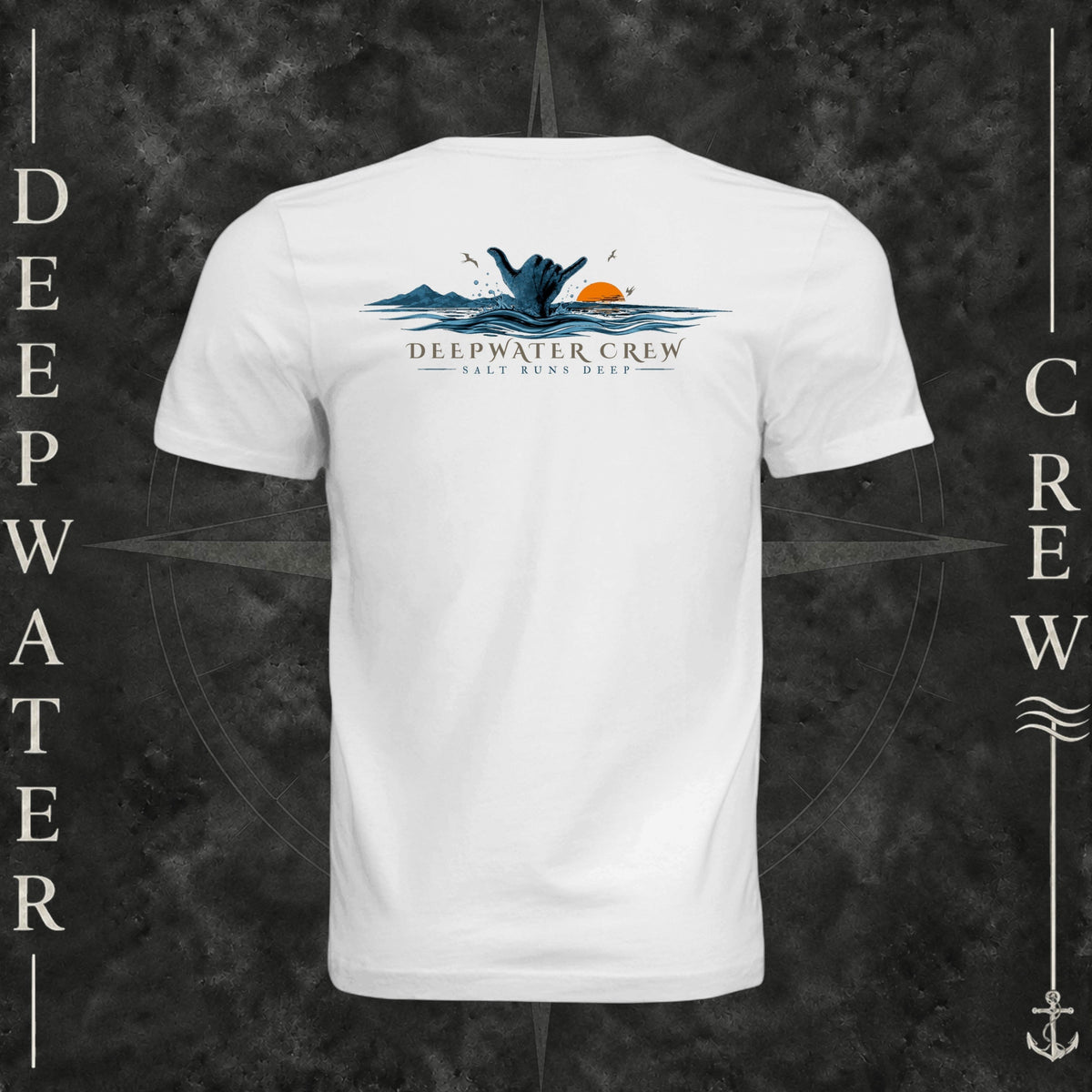 White Deepwater Crew Co. Salt Runs Deep crewneck T-shirt, back view with shaka hand, ocean waves, distant mountains, orange sunset, seabirds, and “Salt Runs Deep” lettering.