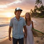 Deepwater Crew Co. trucker cap with white front and black mesh back worn by a man walking on the beach at sunset
