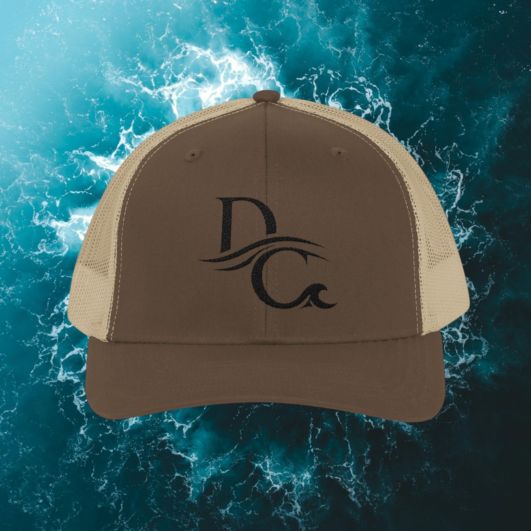 Deepwater Crew Co. brown cotton-polyester trucker hat with mesh back and embroidered DC wave logo.