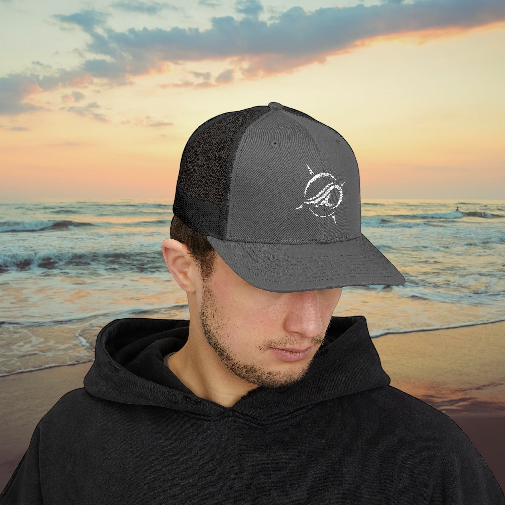 Deepwater Crew Co. charcoal grey trucker hat with white wave logo and black mesh back. Adjustable snapback closure.
