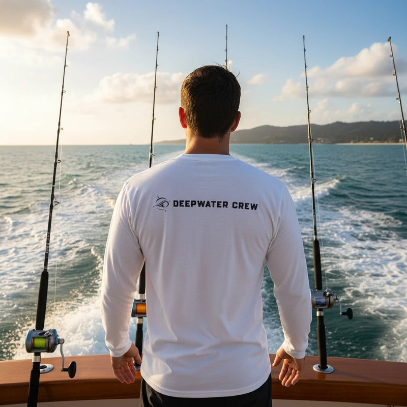 Deepwater Crew Co. white long-sleeve performance sun shirt with brand logo on back, worn by man on a fishing boat.