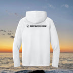 Back view of a white Deepwater Crew Co. UPF performance hoodie with a black logo against a sunset ocean background.
