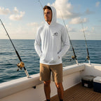 A man wearing a Deepwater Crew Co. white lightweight UPF performance hoodie on a fishing boat at sea.